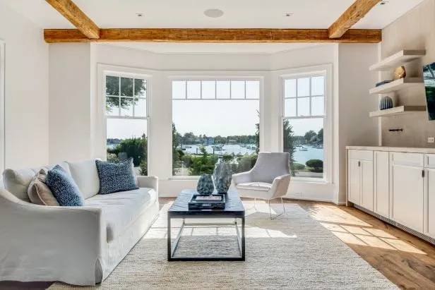 Living room with a wide bay of windows overlooking the water
