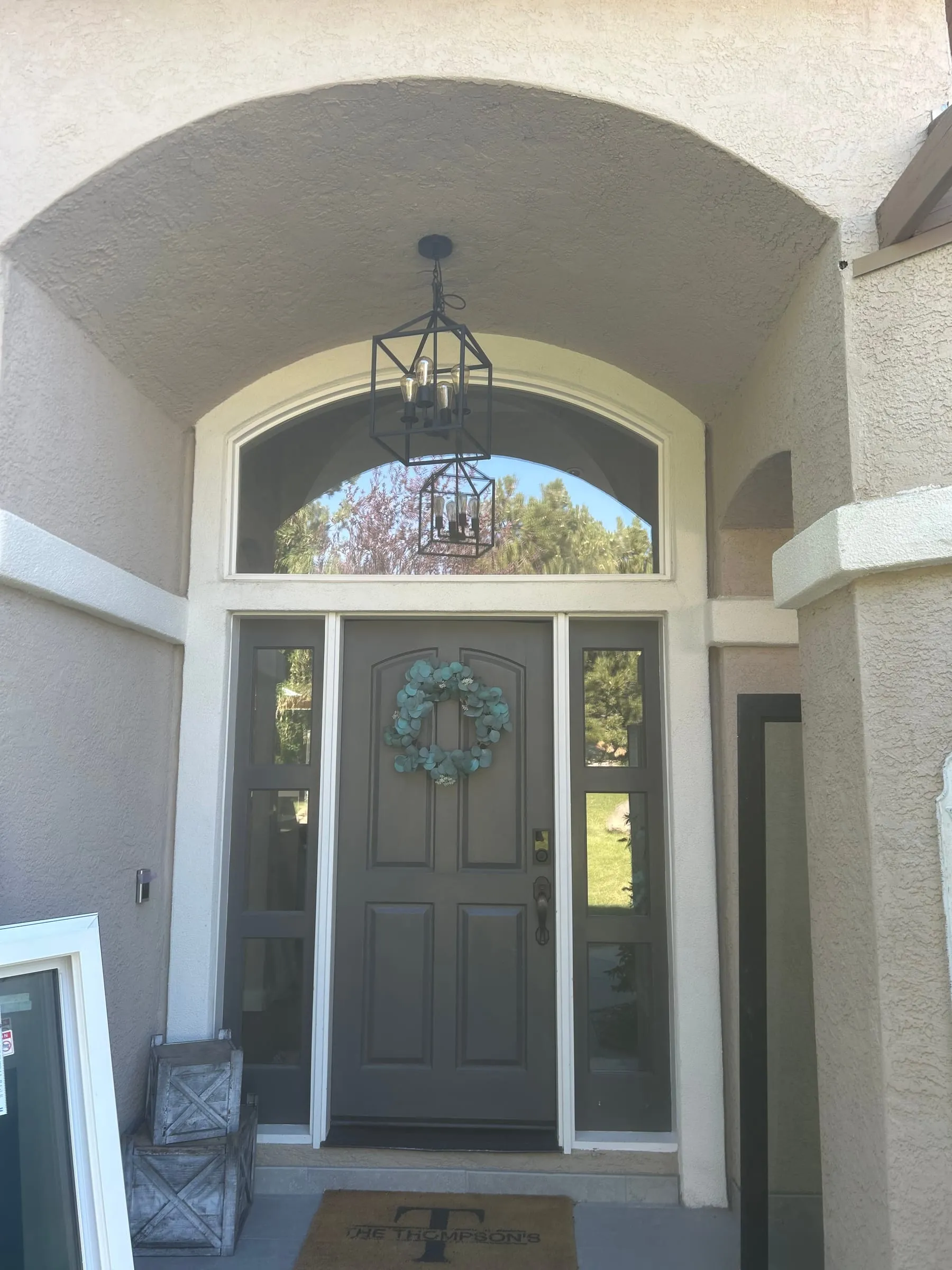 Arched transom window and sidelights around a front door