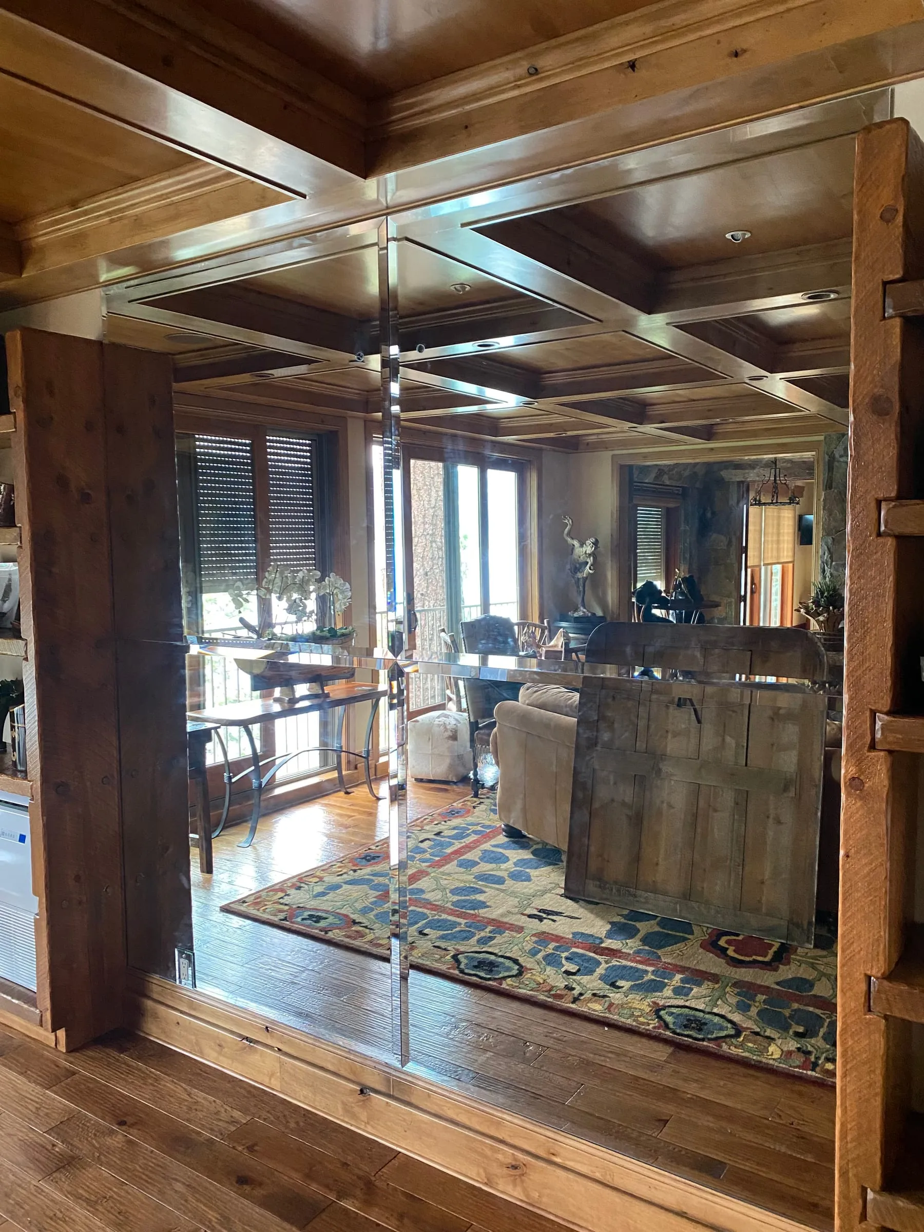 Glass partition set in wood framing in a den