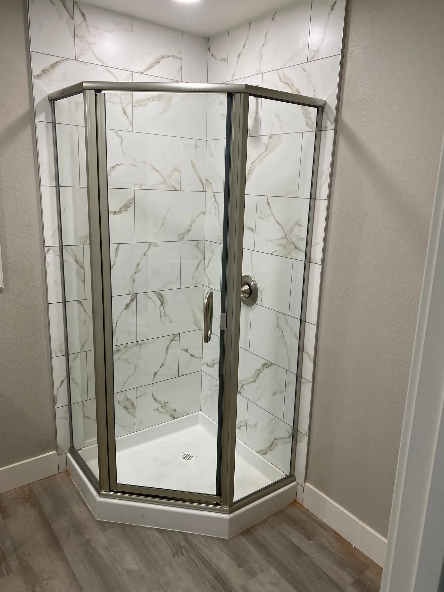 Framed neo-angle shower enclosure with brushed nickel frame