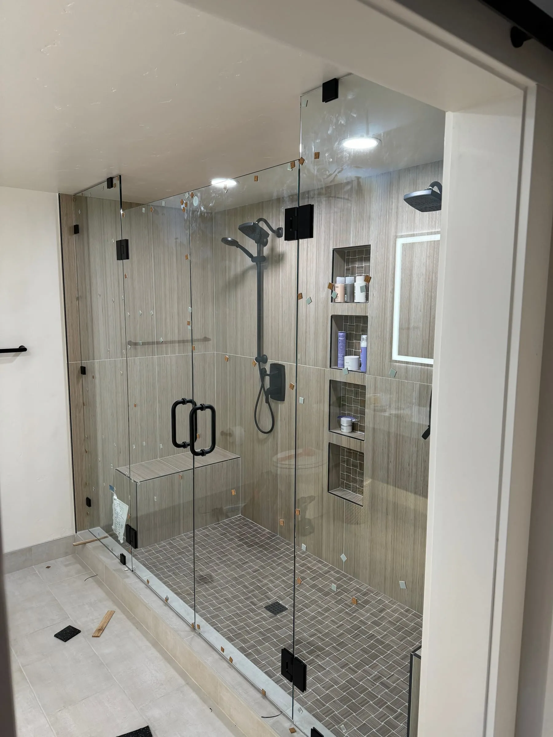 Large frameless glass shower enclosure with matte black hardware
