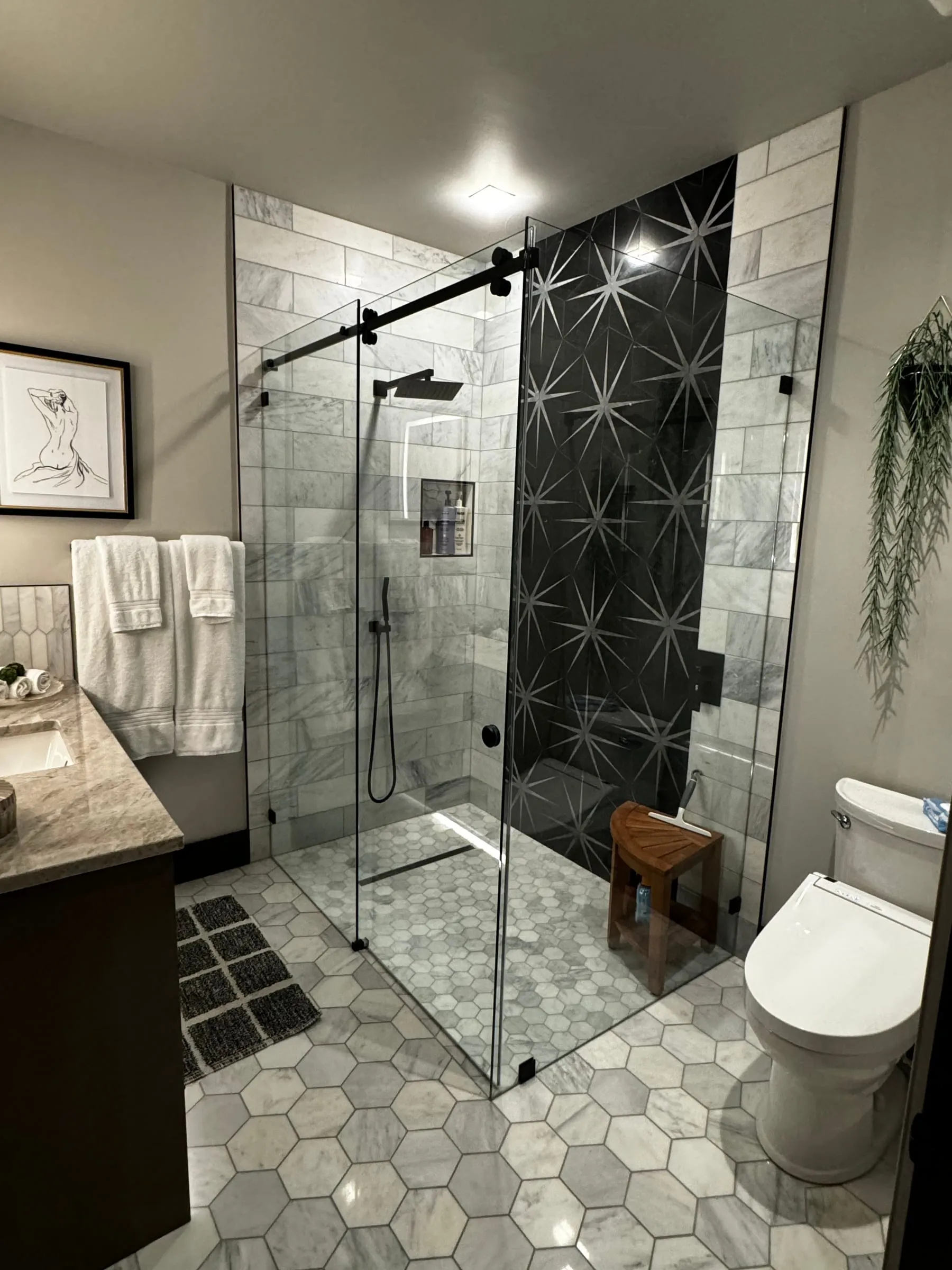 Sliding glass shower door with a matte black track