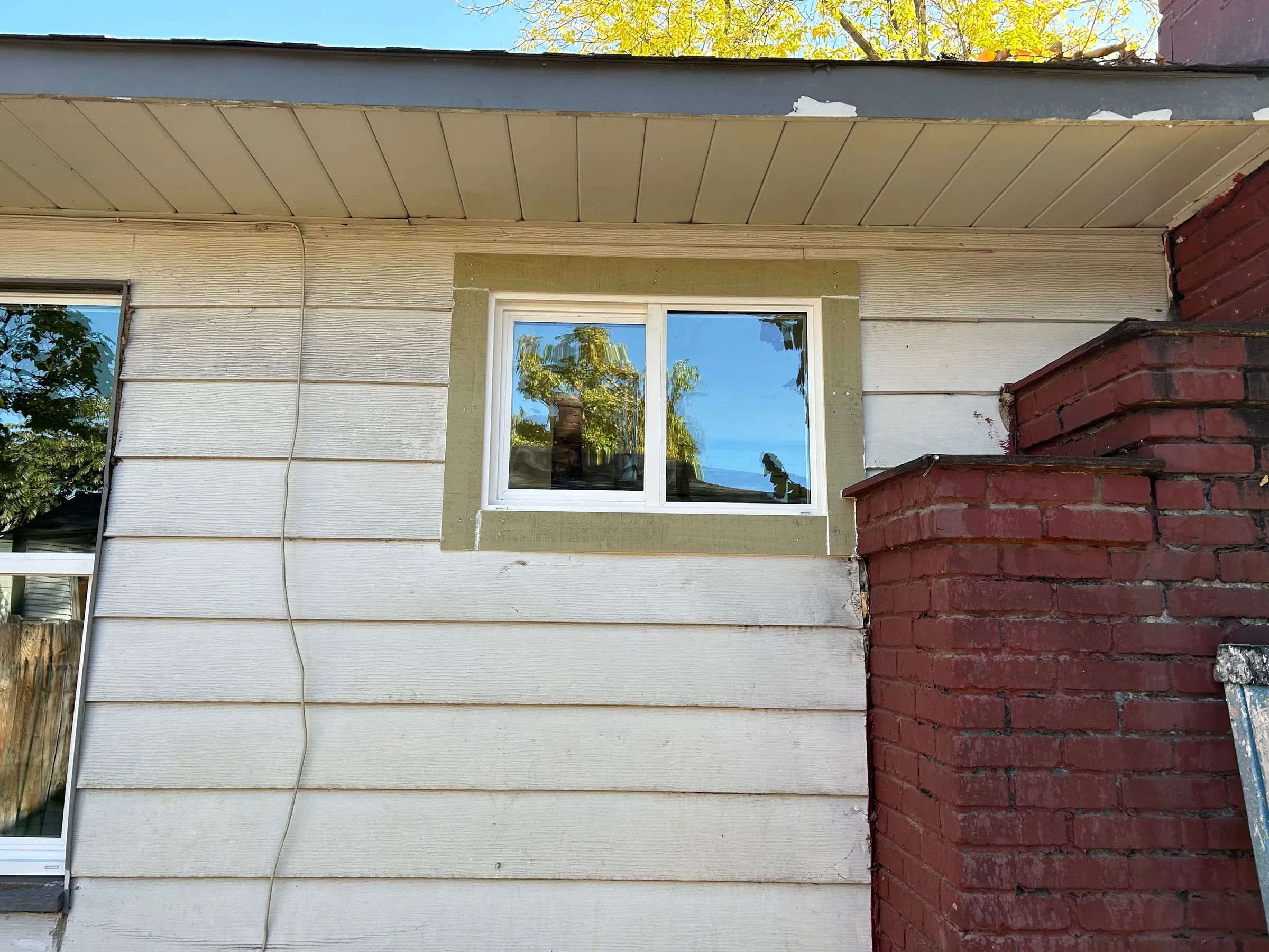 New vinyl window installed in siding