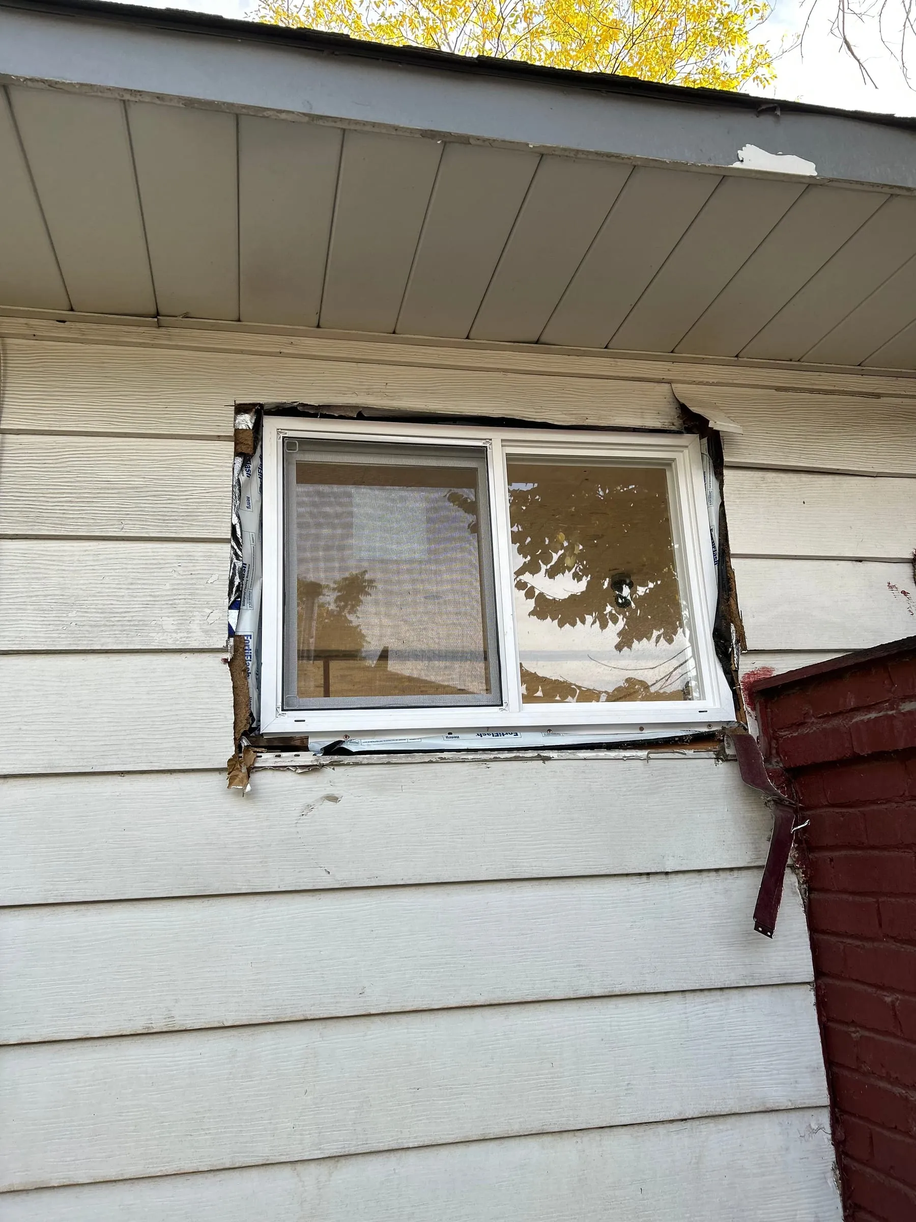 Old window removed from a sided home during replacement